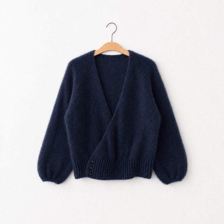 Maiija Crossover in dunkelblauem Mohair, an einer weißen wand hängend